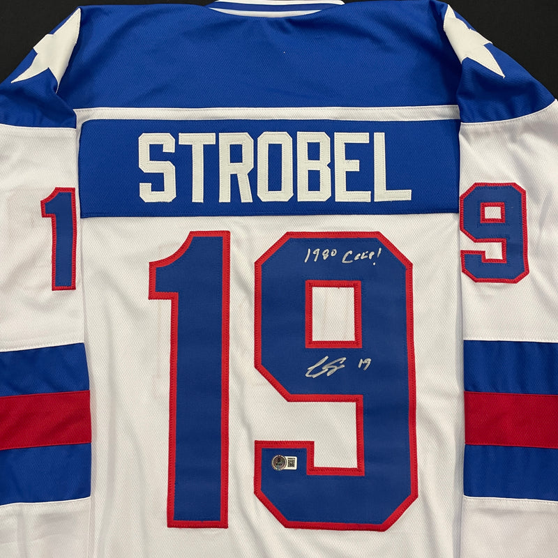 Eric Strobel Autographed USA White Olympic-Style Jersey w/ 1980 Gold Inscription Autographs Fan HQ